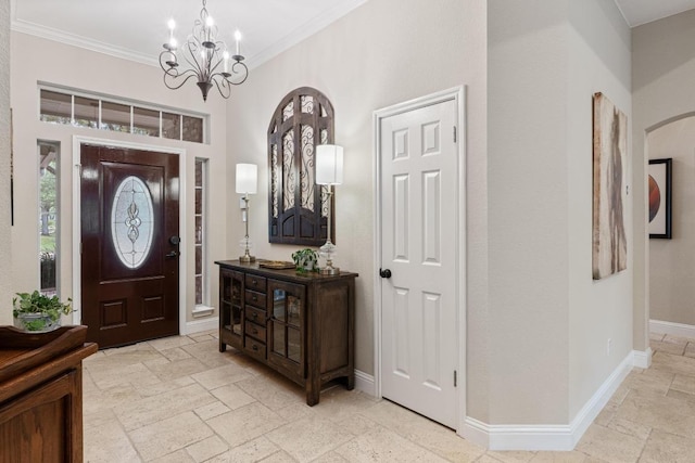 14932 Thatcher Dr, Austin, TX 78717 - foyer entrance with stone tile floors, a chandelier, ornamental molding, and arched walkways