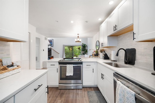 1135 Barton Hills Dr Unit 355, Austin, TX 78704 - kitchen with stainless steel appliances, decorative backsplash, light countertops, a chandelier, and recessed lighting