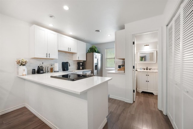 1135 Barton Hills Dr Unit 355, Austin, TX 78704 - kitchen with stainless steel fridge with ice dispenser, wood finished floors, decorative backsplash, white cabinets, and recessed lighting