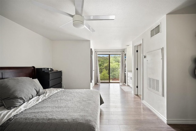 1135 Barton Hills Dr Unit 355, Austin, TX 78704 - bedroom with access to outside, wood finished floors, a textured ceiling, and ceiling fan