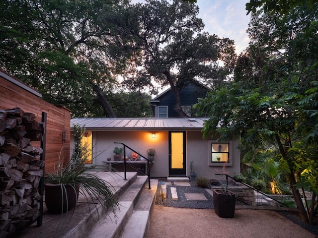 1005 E Riverside Dr, Austin, TX 78704 - view of front of house featuring stucco siding and a metal roof
