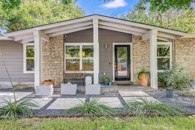 5317 Westminster Dr, Austin, TX 78723 - property entrance featuring covered porch and stone siding