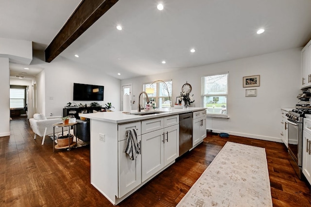 5317 Westminster Dr, Austin, TX 78723 - kitchen featuring stainless steel appliances, open floor plan, an island with sink, recessed lighting, and dark wood finished floors