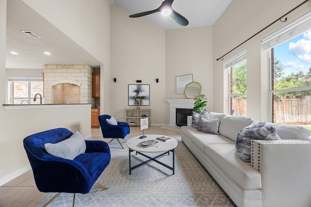 4009 Wilderness Path Bnd, Cedar Park, TX 78613 - living area featuring a fireplace, light tile patterned floors, ceiling fan, a towering ceiling, and recessed lighting
