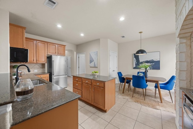 4009 Wilderness Path Bnd, Cedar Park, TX 78613 - kitchen featuring appliances with stainless steel finishes, a kitchen island, tasteful backsplash, recessed lighting, and dark stone counters