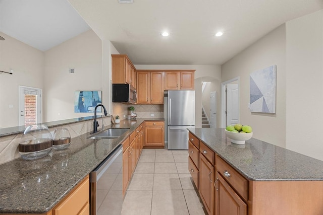 4009 Wilderness Path Bnd, Cedar Park, TX 78613 - kitchen with appliances with stainless steel finishes, backsplash, light tile patterned flooring, dark stone counters, and recessed lighting