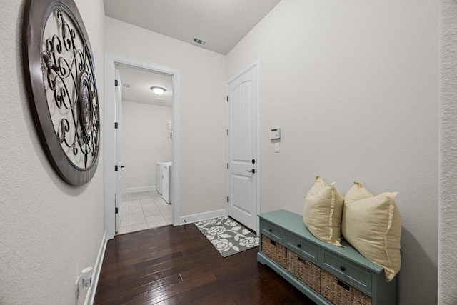 509 Fair Oaks Dr, Georgetown, TX 78628 - foyer entrance with hardwood / wood-style flooring and washer / clothes dryer