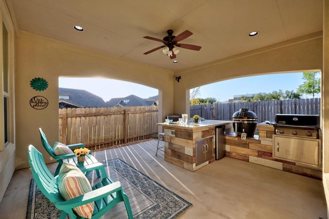 509 Fair Oaks Dr, Georgetown, TX 78628 - fenced backyard with exterior kitchen, a patio area, ceiling fan, and an outdoor bar