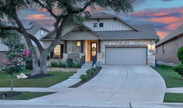 509 Fair Oaks Dr, Georgetown, TX 78628 - view of front facade with stone siding, an attached garage, board and batten siding, driveway, and a front yard
