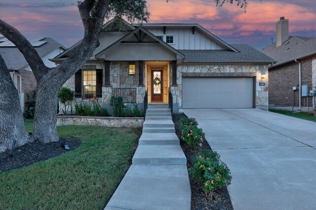 509 Fair Oaks Dr, Georgetown, TX 78628 - view of front of house with stone siding, an attached garage, concrete driveway, and board and batten siding