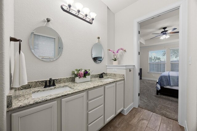 509 Fair Oaks Dr, Georgetown, TX 78628 - ensuite bathroom with double vanity, wood finished floors, and a ceiling fan