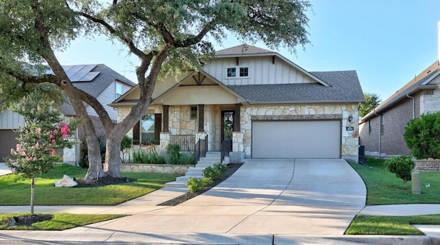 509 Fair Oaks Dr, Georgetown, TX 78628 - view of front of property featuring stone siding, a garage, driveway, and a front yard