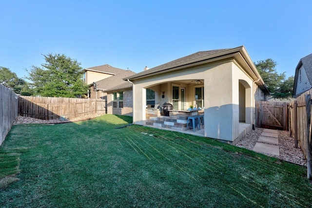 509 Fair Oaks Dr, Georgetown, TX 78628 - rear view of property featuring an outdoor kitchen, a fenced backyard, a patio, and stucco siding