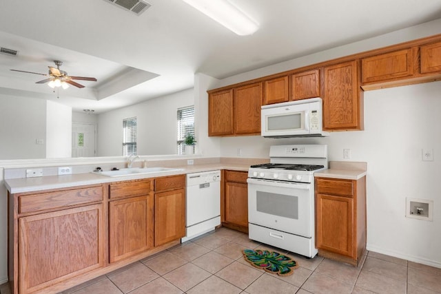 109 Onyx Lake Dr, Kyle, TX 78640 - kitchen featuring white appliances, a peninsula, light countertops, and a ceiling fan
