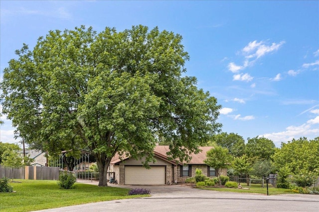 1601 Samoa Ct, Pflugerville, TX 78660 - view of property hidden behind natural elements with a garage and driveway