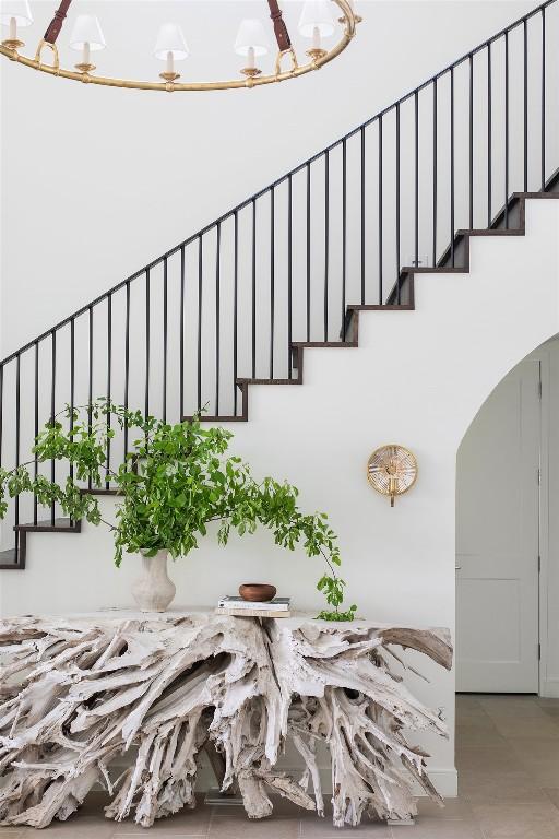 4401 Amarra Dr Unit 19, Austin, TX 78735 - stairs featuring a chandelier and arched walkways