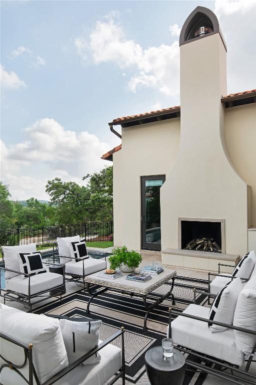 4401 Amarra Dr Unit 19, Austin, TX 78735 - view of patio / terrace with an outdoor living space with a fireplace