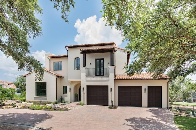 4401 Amarra Dr Unit 19, Austin, TX 78735 - mediterranean / spanish-style house with a balcony, a tiled roof, a garage, decorative driveway, and stucco siding