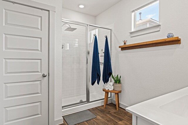 112 Wichita River Rd, Hutto, TX 78634 - bathroom with a stall shower, wood finished floors, and recessed lighting