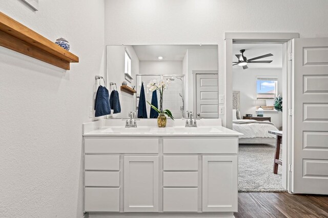 112 Wichita River Rd, Hutto, TX 78634 - ensuite bathroom with a stall shower, ceiling fan, double vanity, and wood finished floors