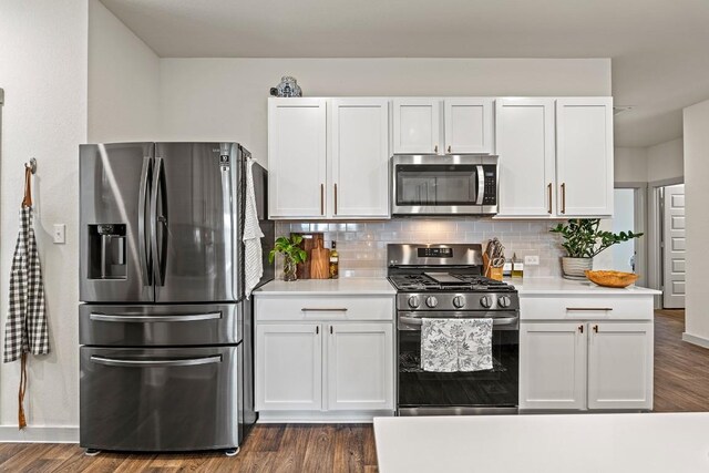 112 Wichita River Rd, Hutto, TX 78634 - kitchen with stainless steel appliances, light countertops, white cabinetry, tasteful backsplash, and dark wood-style flooring