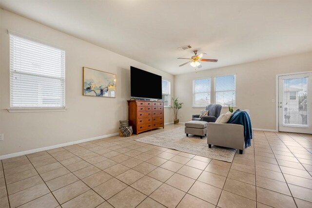 221 Pearl Way, Buda, TX 78610 - living area with light tile patterned floors, healthy amount of natural light, and ceiling fan