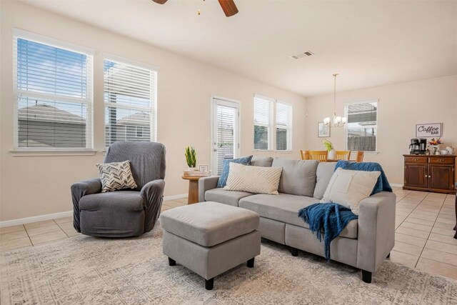 221 Pearl Way, Buda, TX 78610 - living room with light tile patterned floors, a chandelier, and a ceiling fan