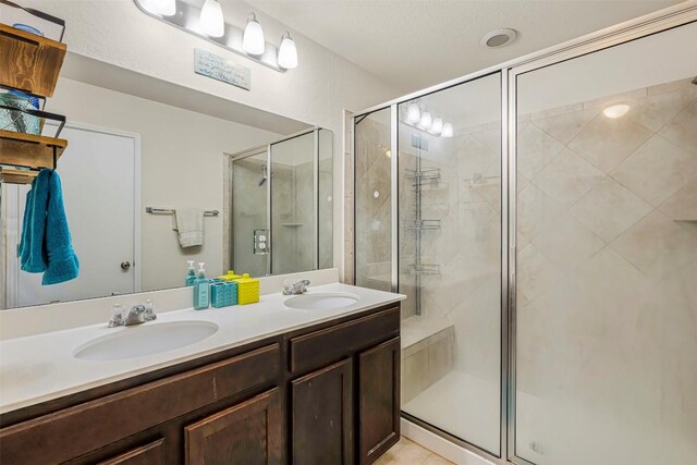 221 Pearl Way, Buda, TX 78610 - bathroom featuring a shower stall and double vanity