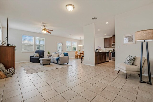 221 Pearl Way, Buda, TX 78610 - living area with light tile patterned floors, a chandelier, ceiling fan, and recessed lighting