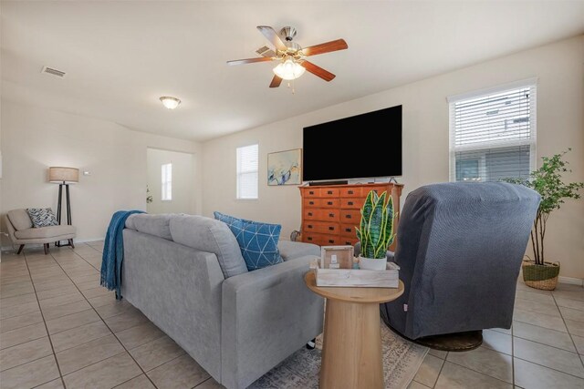 221 Pearl Way, Buda, TX 78610 - living area with light tile patterned floors, healthy amount of natural light, and ceiling fan