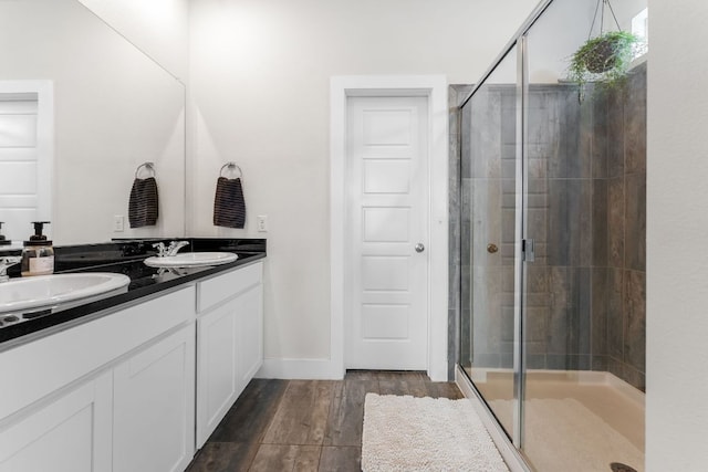 3800 Bristol Motor Pass, Austin, TX 78728 - bathroom featuring a shower stall, double vanity, and wood finished floors
