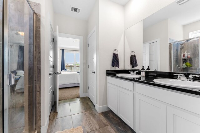 3800 Bristol Motor Pass, Austin, TX 78728 - ensuite bathroom featuring double vanity, a stall shower, and tile patterned flooring