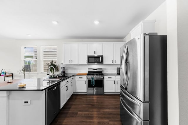 3800 Bristol Motor Pass, Austin, TX 78728 - kitchen with appliances with stainless steel finishes, white cabinets, dark wood finished floors, decorative backsplash, and recessed lighting