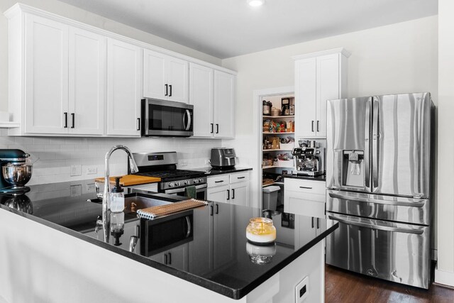 3800 Bristol Motor Pass, Austin, TX 78728 - kitchen featuring appliances with stainless steel finishes, dark countertops, tasteful backsplash, and white cabinets