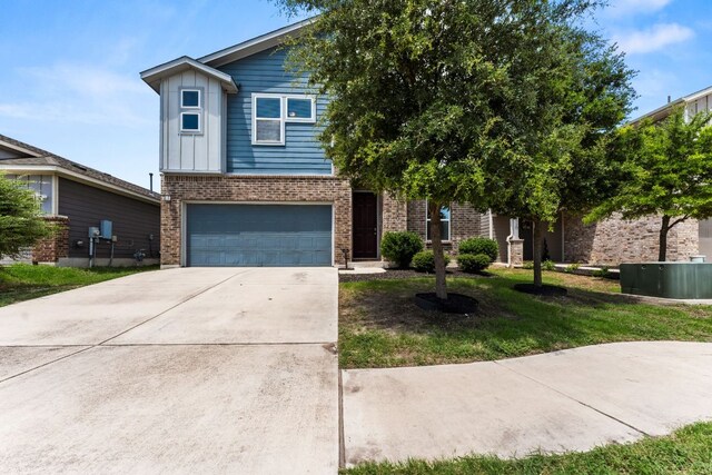 3800 Bristol Motor Pass, Austin, TX 78728 - view of front of house with brick siding, an attached garage, driveway, board and batten siding, and a front yard
