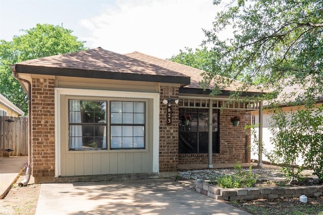 823 Topaz Ln, Leander, TX 78641 - view of front of home featuring brick siding, roof with shingles, and a patio