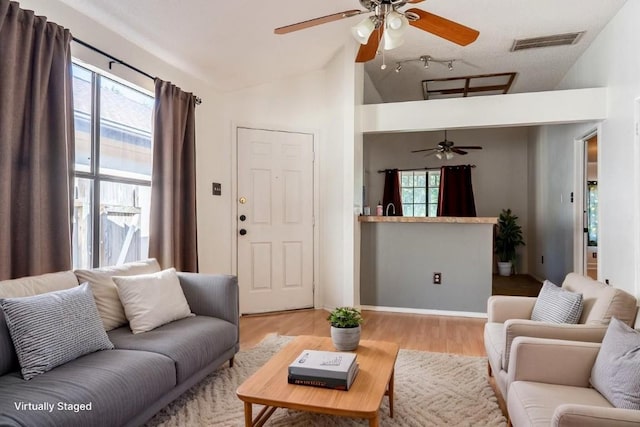 823 Topaz Ln, Leander, TX 78641 - living area with ceiling fan, vaulted ceiling, plenty of natural light, and wood finished floors