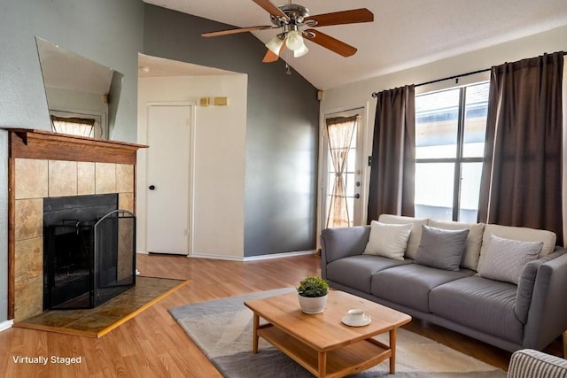 823 Topaz Ln, Leander, TX 78641 - living area with vaulted ceiling, a ceiling fan, wood finished floors, and a fireplace