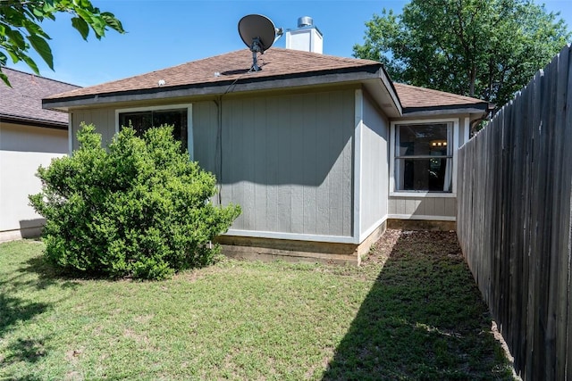 823 Topaz Ln, Leander, TX 78641 - view of side of property featuring roof with shingles and a chimney
