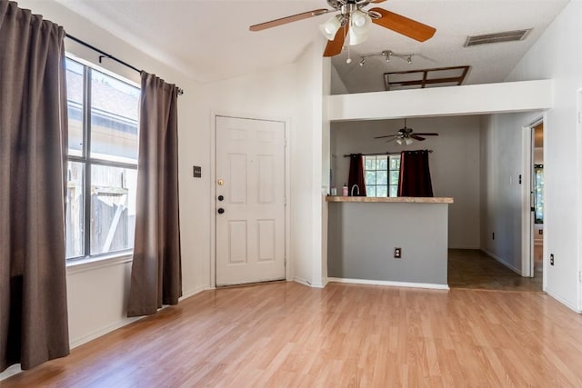 823 Topaz Ln, Leander, TX 78641 - foyer entrance featuring lofted ceiling, ceiling fan, and light wood-style floors