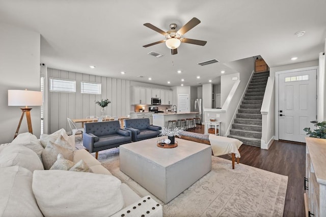 7506 Chesapeake Rail Ln, Austin, TX 78744 - living room featuring a ceiling fan, stairway, dark wood-style floors, and recessed lighting
