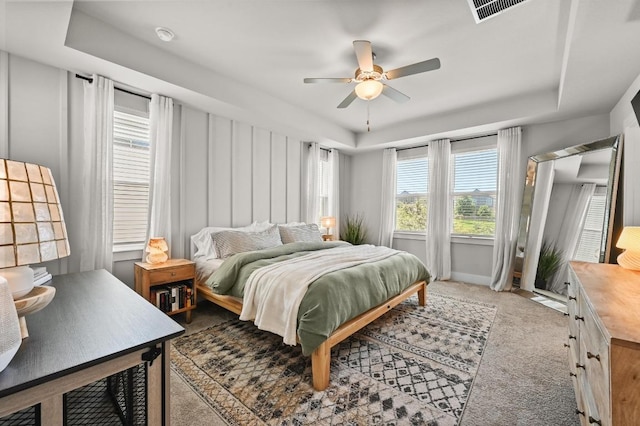 7506 Chesapeake Rail Ln, Austin, TX 78744 - bedroom featuring a tray ceiling, carpet, and ceiling fan