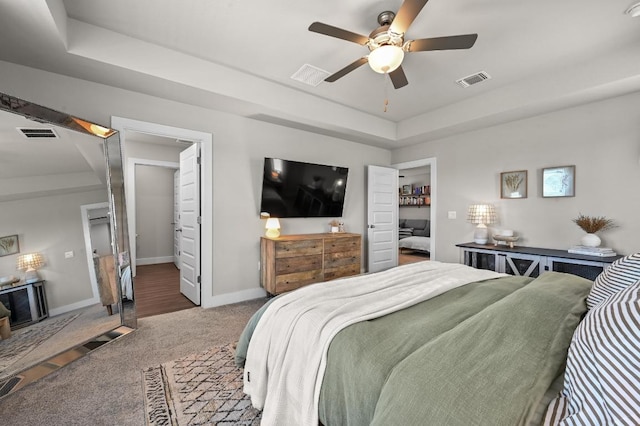 7506 Chesapeake Rail Ln, Austin, TX 78744 - carpeted bedroom featuring a tray ceiling and a ceiling fan