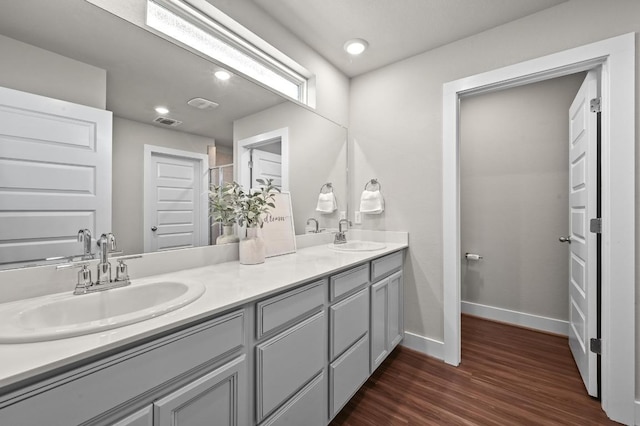 7506 Chesapeake Rail Ln, Austin, TX 78744 - full bath featuring double vanity, wood finished floors, and recessed lighting