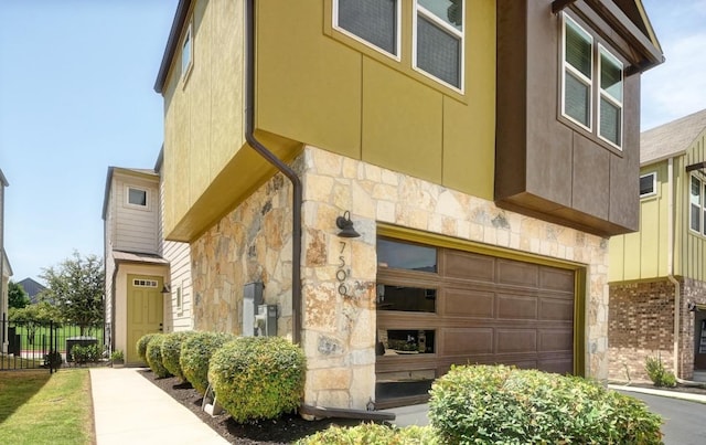 7506 Chesapeake Rail Ln, Austin, TX 78744 - view of side of home featuring stone siding and an attached garage