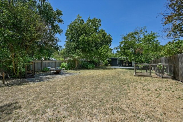 8415 Bowling Green Dr, Austin, TX 78757 - fenced backyard with a patio area and a vegetable garden