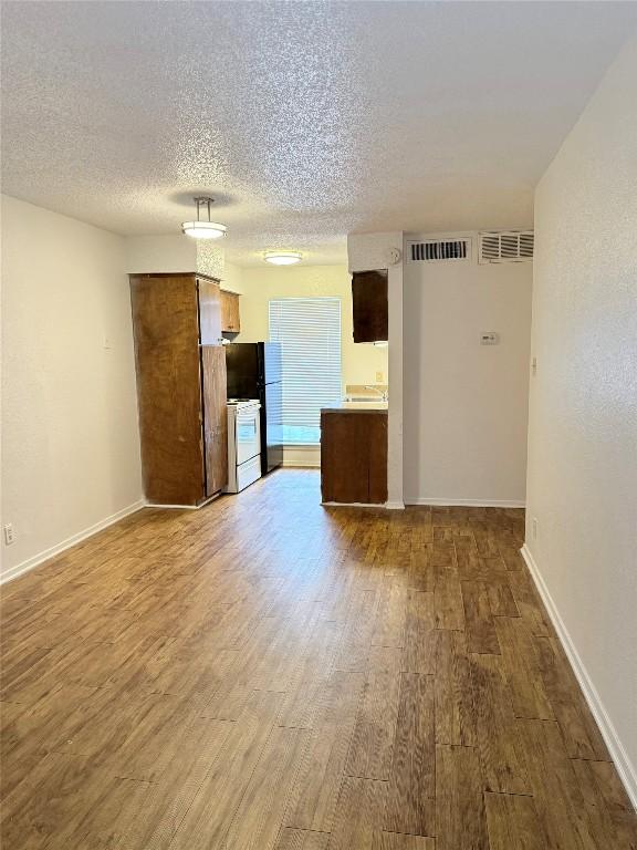 2803 Hemphill Park Unit B209, Austin, TX 78705 - unfurnished room with wood finished floors and a textured ceiling