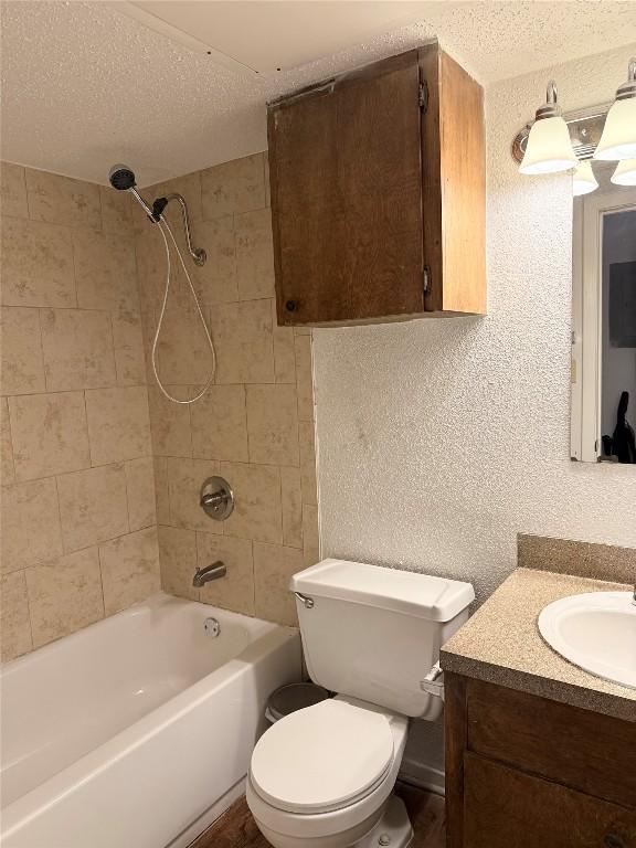 2803 Hemphill Park Unit B209, Austin, TX 78705 - bathroom featuring vanity, a textured ceiling,  shower combination, and a textured wall