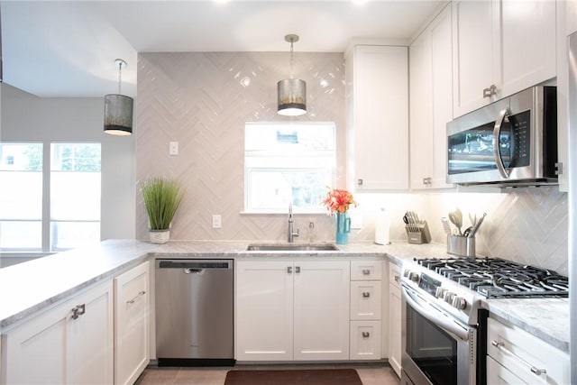 6613 Woodrow Ave, Austin, TX 78757 - kitchen featuring stainless steel appliances, white cabinets, and backsplash