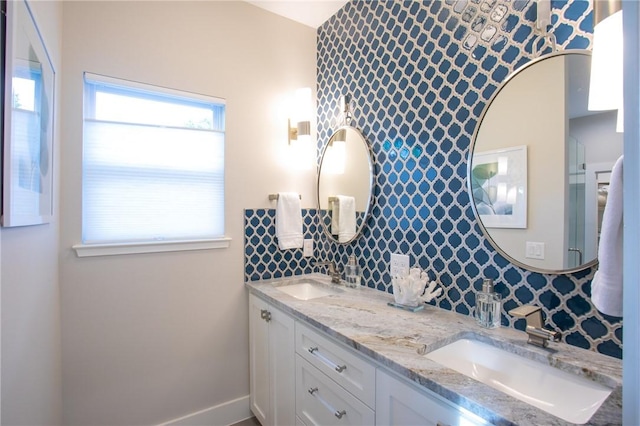 6613 Woodrow Ave, Austin, TX 78757 - full bath with tasteful backsplash, double vanity, and an accent wall